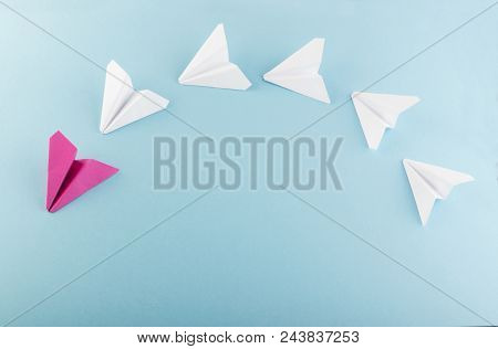 One Unique Pink Paper Plane Among Many Ones. Different Paper Airplanes As Individuality And Leadersh