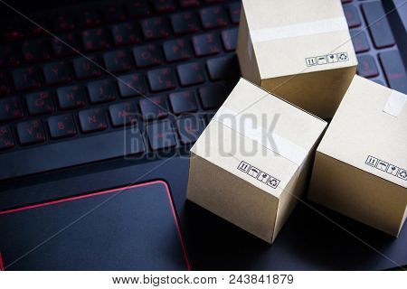 Online Shopping Concept E-commerce Delivery Buying Service. Square Cartons Shopping On Laptop Keyboa