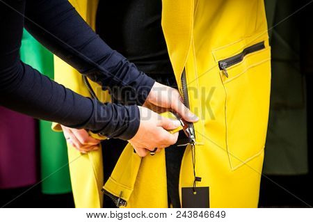 Fitting softshell coat in a store. Fashion conception.