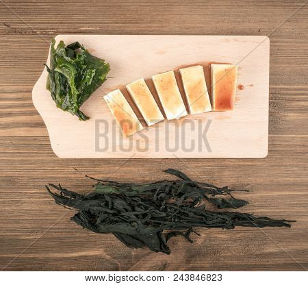 Wakame Seaweed On Natural Stone Background. Healthy Algae Food With Soy Sauce And Tofu