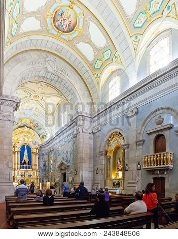 Terras de Bouro, Portugal. April 06, 2015: Faithful praying in the interior of the Sanctuary of Sao Bento da Porta Aberta. Pope Francis promoted it to Basilica in the 400th anniversary in March, 21st