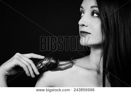 Black And White Portrait Of Attractive Young Girl With Big Snail On Shoulder On In Studio. Cosmetolo
