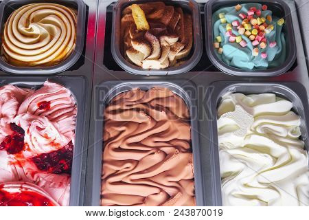 Delicious Ice Cream Of Different Flavors And Colors On A Confectionery Shop