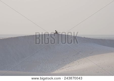 Man Praying On Top Of Sand Dune. Socotra Island, Yemen