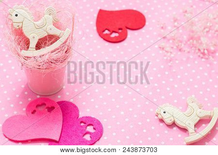 Pink Baby Girl Theme. 2 Rocking Ponies Toys In Pink Small Bucket With Straw And Felt Hearts Flat Lay
