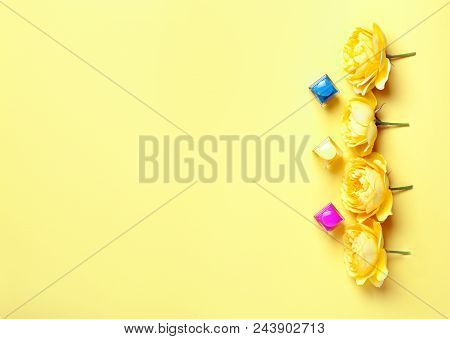 Nail Polish Bottle And Yellow Roses On Yellow Background. Trendy Manicure Concept, Pure Colors. Top 