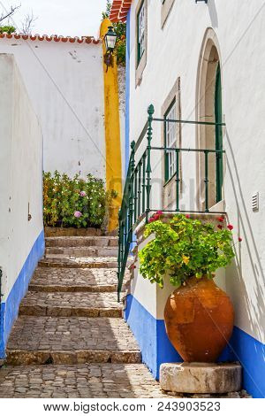 Obidos, Portugal. Typical medieval street. Obidos is a medieval town still inside the walls, and very popular among tourists.