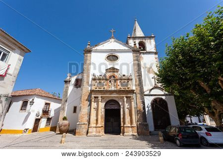 Obidos, Portugal. Medieval Santa Maria Church showing a Renaissance Portal. Obidos is a medieval town inside walls, and very popular among tourists.
