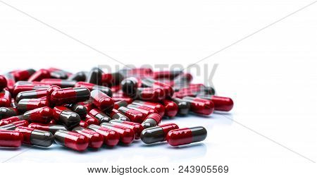 Pile Of Red And Grey Capsule Pills Isolated On White Background With Copy Space. Flunarizine : Drug 
