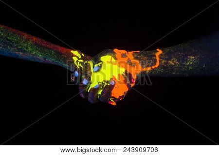 Concept Of Connecting Hands Creative Shooting In Neon Light Male And Female Palms Together