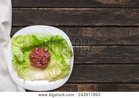 Cabbage Roll On The White Plate. Raw Minced Pork With Beef In Cabbage Green Leaves.