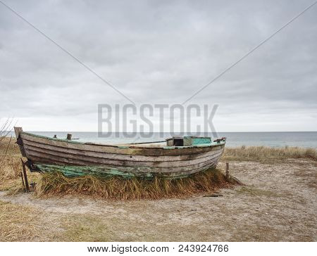 Fishermens Boat At Seacoast, On Sand At Sunset With Horizon Sea On Background. Background Of Sea Wit