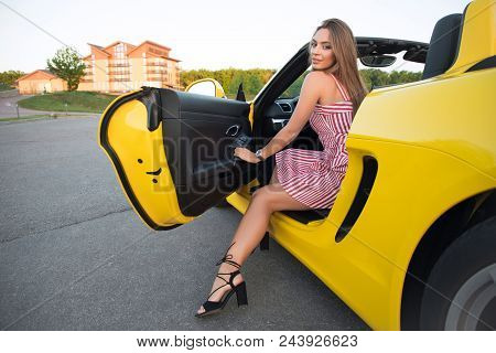 The Ideal Life! Smiling Tender Beautiful Young Sexy Woman Sitting On The Drivers Seat Of Her Yellow 