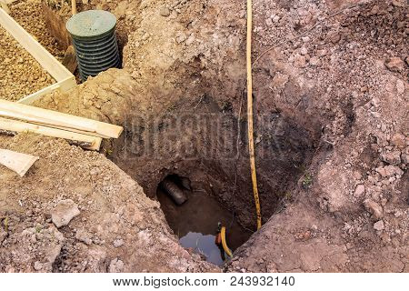 View Of The Construction Site With Trenches For The Foundation And Pump Pumping Water For Dehumidifi