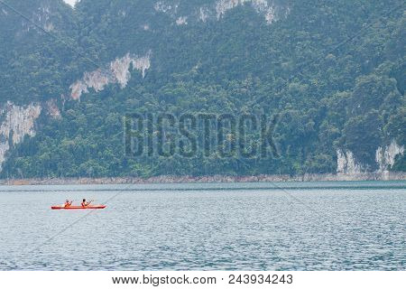 Travellers Are Sailing The Orange Boat In The Sea In Thailand