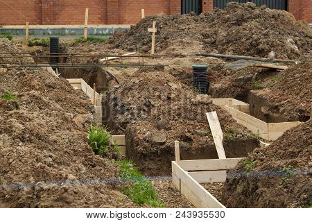 Inspection Well, Drainage Pipe And Trench With Formwork, Which Is Prepared For Pouring The Foundatio