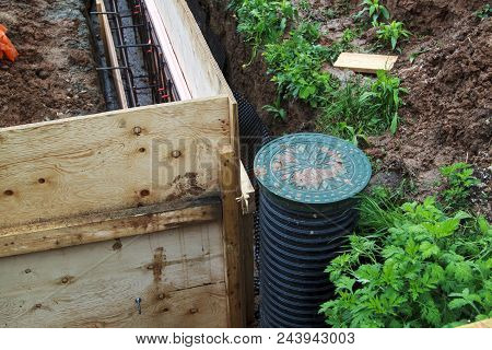 Inspection Well And Trench With Wooden Formwork. Preparation For Pouring The Foundation