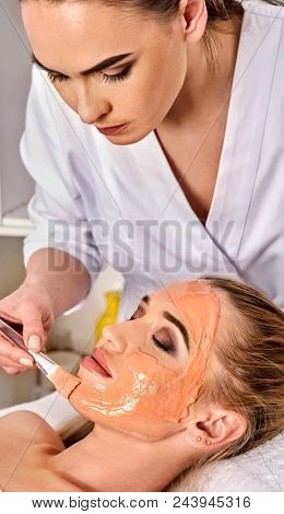 Collagen face mask. Facial skin treatment. Face of woman receiving cosmetic procedure in beauty salon close up number one isolated. Summer discounts for visiting spa salon.