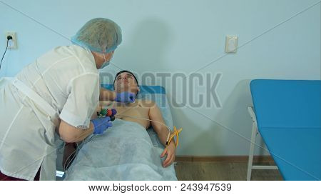 Nurse Preparing Patient's Chest To Attach Electrode Pads For Ecg