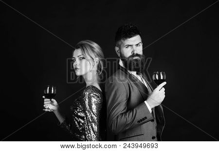 Red Wine. Lady And Gentleman With Serious Faces Tasting Italian Alcohol. Couple In Love Holding Glas