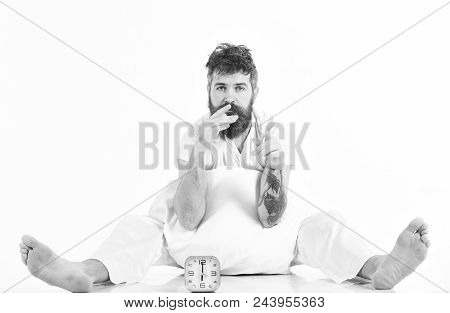 Good Morning. Man Sitting In Pajama With Bored Or Exhausted Face, White Background. Hipster With Bea