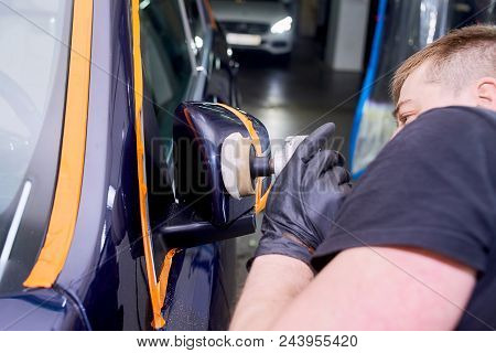 A Man Is Polishing A Blue Car. Polishing Machine And Polishing Paste For Gloss.