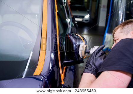A Man Is Polishing A Blue Car. Polishing Machine And Polishing Paste For Gloss.