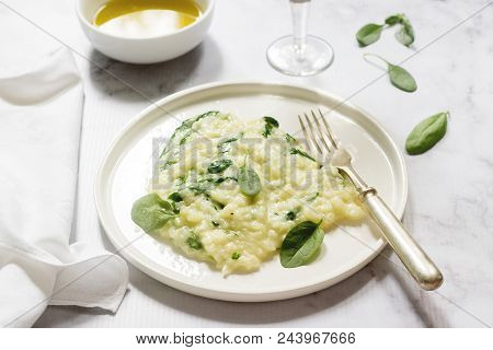 Gentle Cream Risotto With Spinach, Served With Wine. Light Background, Selective Focus.