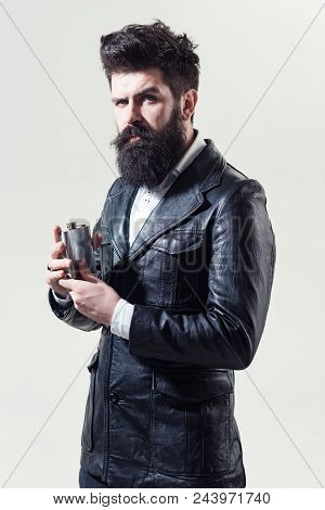 Bearded Man With Long Beard And Moustache Holds Flask. Fashion. Trendy Clothes. Bearded Man In Black