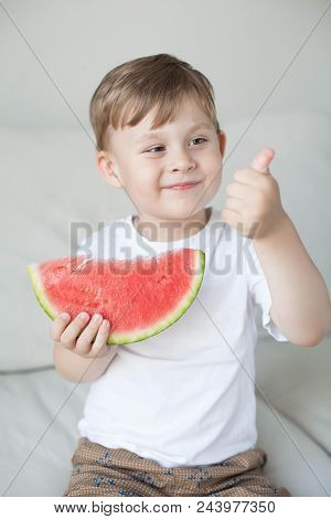 A Small Cute Boy 4 Years Old Is Eating A Watermelon. Summer. Heat. Watermelon. Portrait Of A Happy B