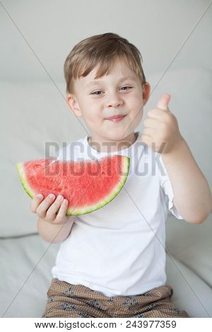 A Small Cute Boy 4 Years Old Is Eating A Watermelon. Summer. Heat. Watermelon. Portrait Of A Happy B