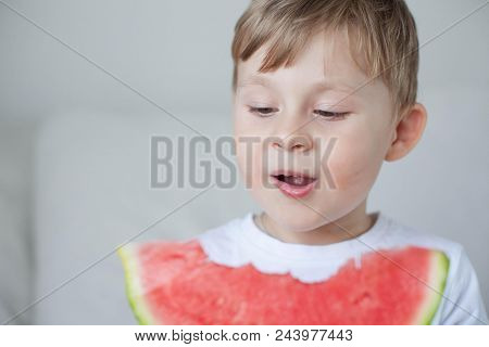 A Small Cute Boy 4 Years Old Is Eating A Watermelon. Summer. Heat. Watermelon. Portrait Of A Happy B