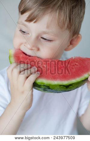 A Small Cute Boy 4 Years Old Is Eating A Watermelon. Summer. Heat. Watermelon. Portrait Of A Happy B