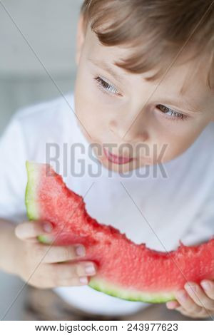 A Small Cute Boy 4 Years Old Is Eating A Watermelon. Summer. Heat. Watermelon. Portrait Of A Happy B