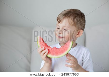 A Small Cute Boy 4 Years Old Is Eating A Watermelon. Summer. Heat. Watermelon. Portrait Of A Happy B