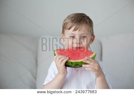 A Small Cute Boy 4 Years Old Is Eating A Watermelon. Summer. Heat. Watermelon. Portrait Of A Happy B