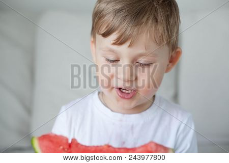 A Small Cute Boy 4 Years Old Is Eating A Watermelon. Summer. Heat. Watermelon. Portrait Of A Happy B