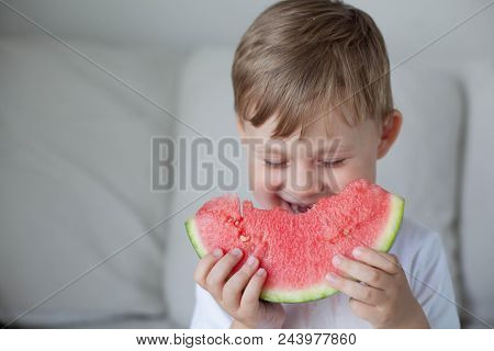 A Small Cute Boy 4 Years Old Is Eating A Watermelon. Summer. Heat. Watermelon. Portrait Of A Happy B