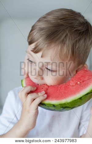 A Small Cute Boy 4 Years Old Is Eating A Watermelon. Summer. Heat. Watermelon. Portrait Of A Happy B