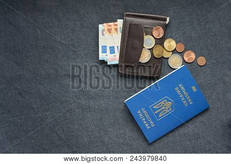Blue Ukrainian Passport On Gray Background With Euro Monay In Purse