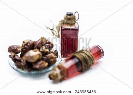 Sweet And Floral Essence Of Date Or Khajoor In Bottles Isolated On White Used In Flavored Chocolate 