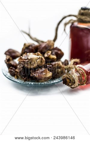 Sweet And Floral Essence Of Date Or Khajoor In Bottles Isolated On White Used In Flavored Chocolate