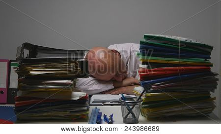 Tired Businessman Image Sleeping On The Desk In Financial Archive Office Room
