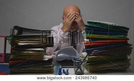 Tired Businessman Working Hard In Archive Room With Many Documents