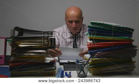 Preoccupied Businessman Reading Banking Documents In Accounting Archive Room