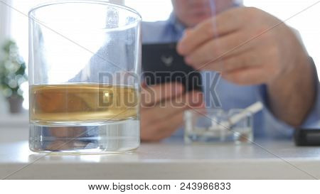 Relaxed Person Drink Alcohol Smoke Cigarette And Text Cell Phone