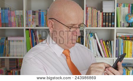 Businessperson Wearing Eyeglasses Text Using Cell Phone Inside Office Room