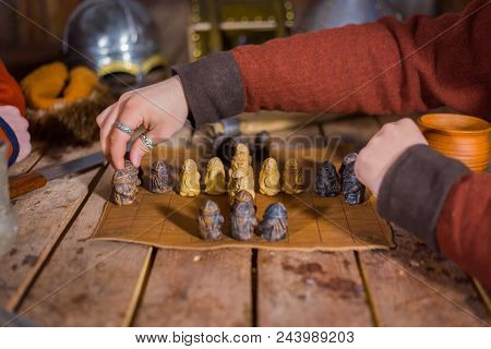 Close Up Shot - Two Men In Russian Ethnic Suit Playing Medieval Popular Strategy Board Game - Tafl. 