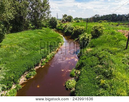 Dirty Brown River. Pollution Concept. Green Riverside