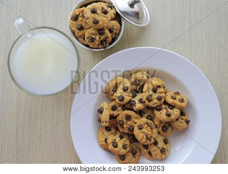 Some Chocolate Chips Cookies On White Plate Served With Milk In Flaylay Style
